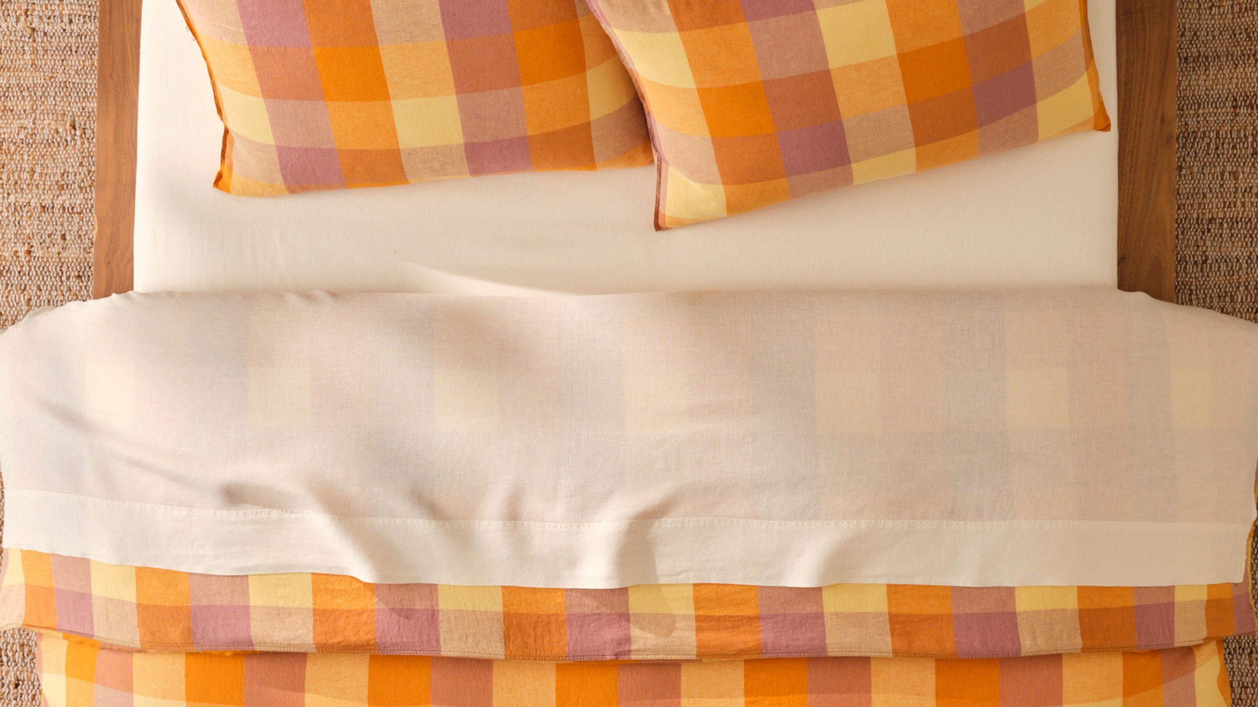 Brooklinen plaid bedding for fall 2026 styled with clean ivory sheets in a neutral bedroom