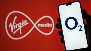 Person holding phone showing O2 logo in front of Virgin Media logo