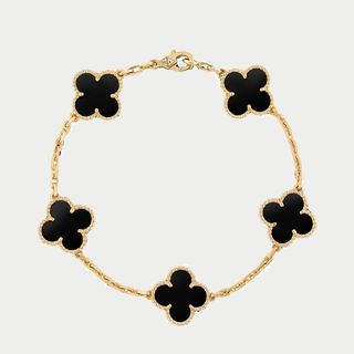 flat lay image of black and gold bracelet