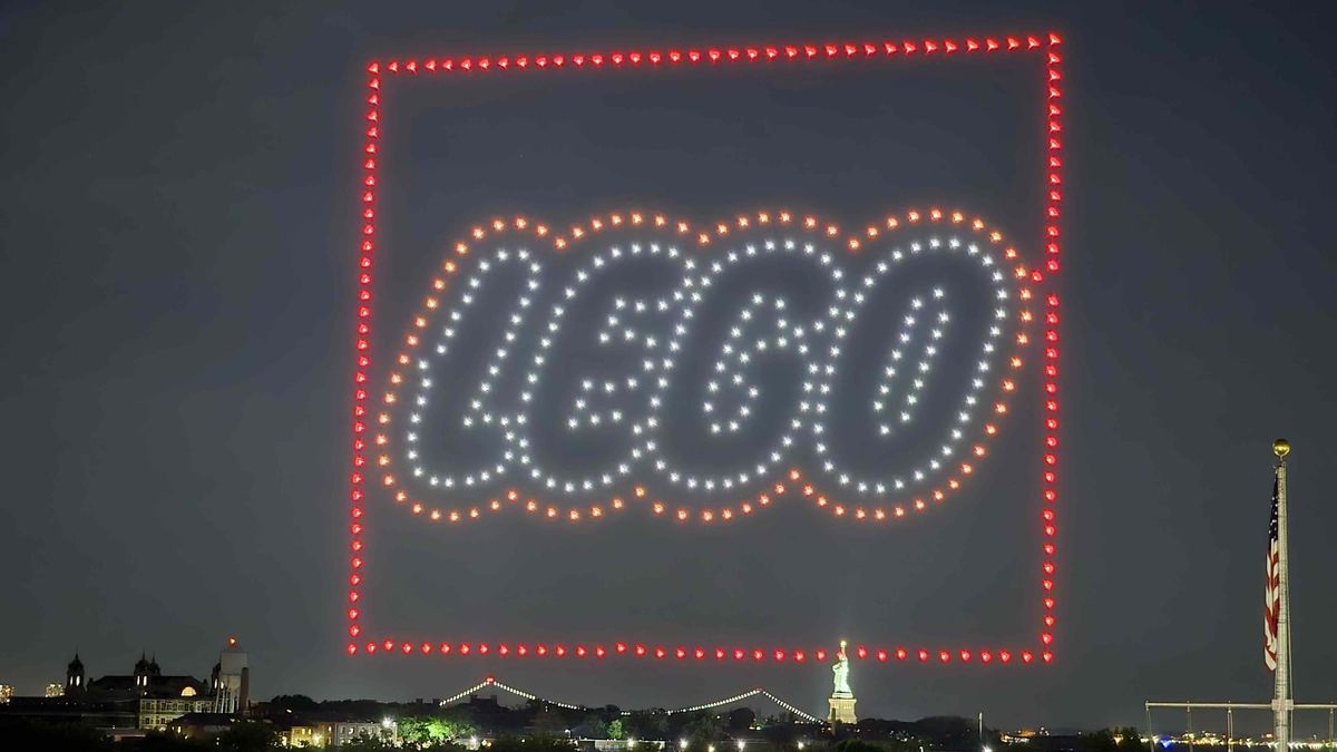 Lego logo illuminated by drones in NYC sky.