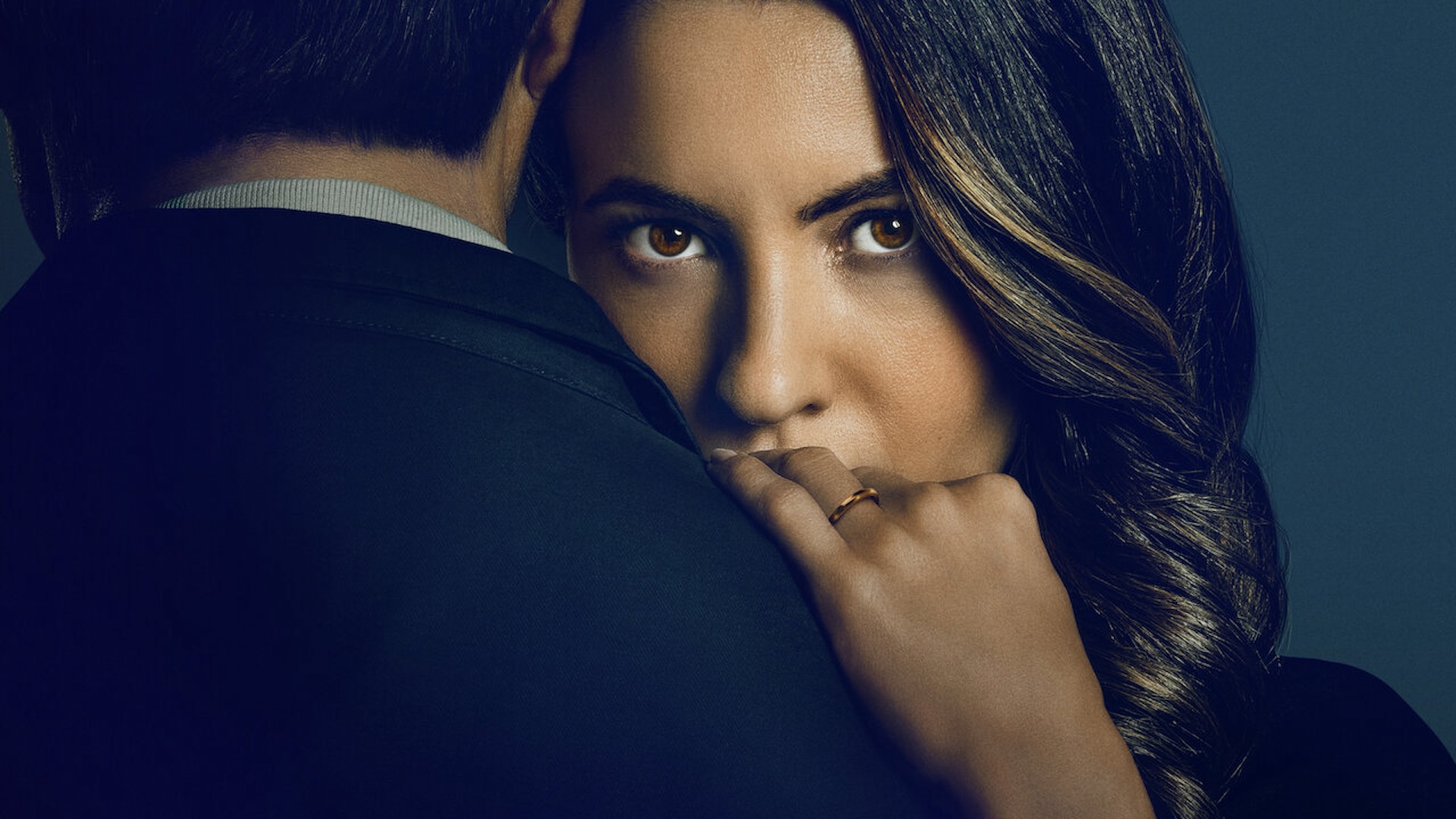 A woman staring over a mans shoulder 