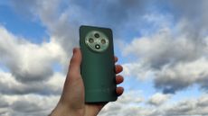 The Oppo Reno 12 FS 5G against a partially overcast sky