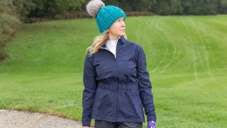 A golfer wears the FootJoy Women's HydroLite Jacket
