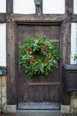 Daylesford natural christmas wreath on a historic wooden front door