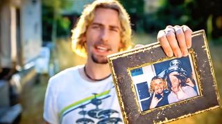 Nickelback. frontman Chad Kroeger holds a framed picture in a still from the band's Photograph video