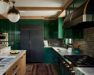 kitchen with black appliances and emerald green cabinets