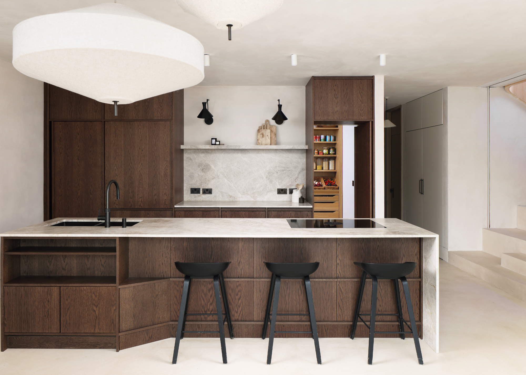 modern kitchen with dark wooden cabinetry and a stone island