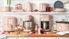 The Beautiful by Drew Barrymore cookware collection on a counter in its new colorway, Rosé pink