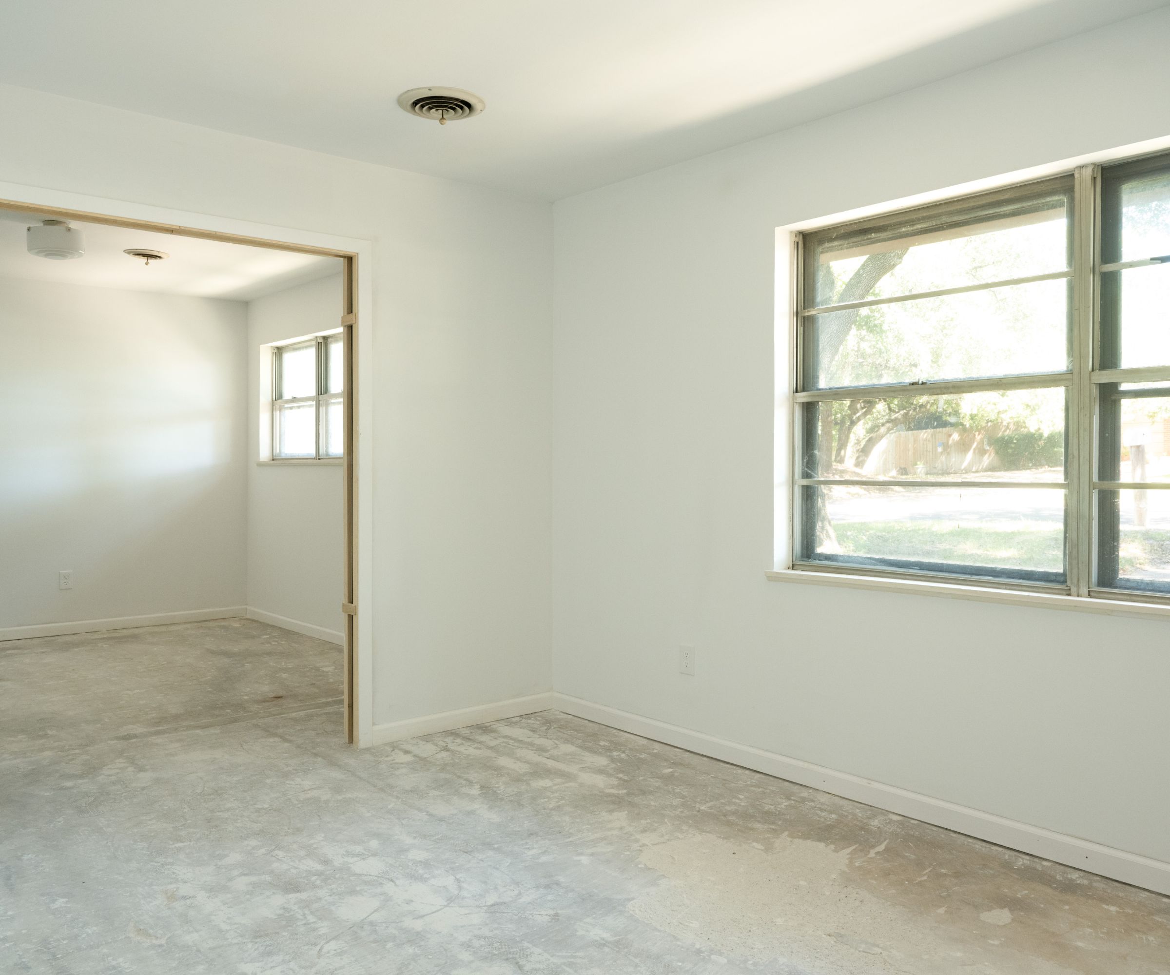 Empty room with white walls, carpet and doorway
