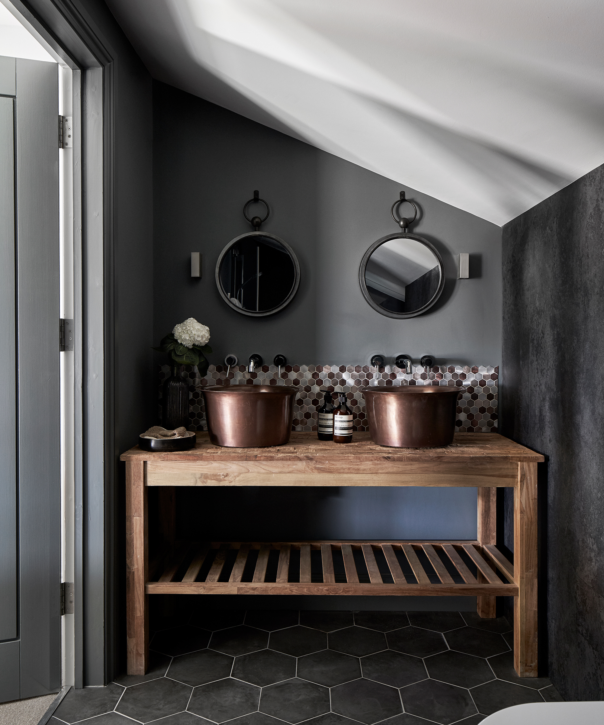 Hexagonal tiled flooring and splashback in a small bathroom