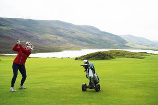 Female golfer hits a shot at Asta Golf Club