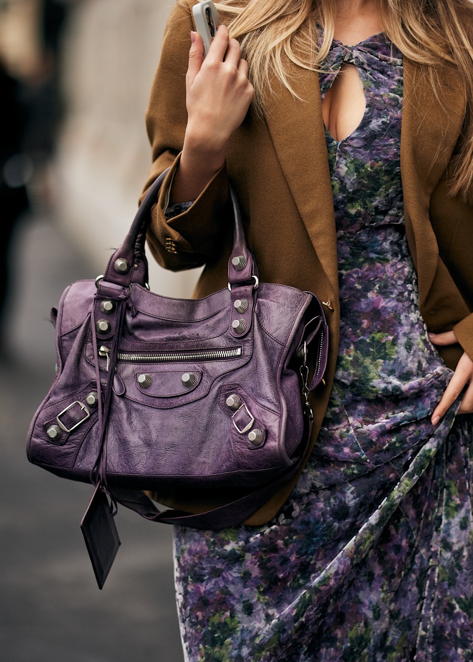 woman wearing a dress, jacket, and slouchy bag