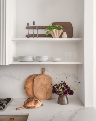 wooden cutting boards on a grey kitchen counter