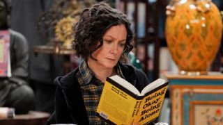 Darlene reading self-help book in The Conners