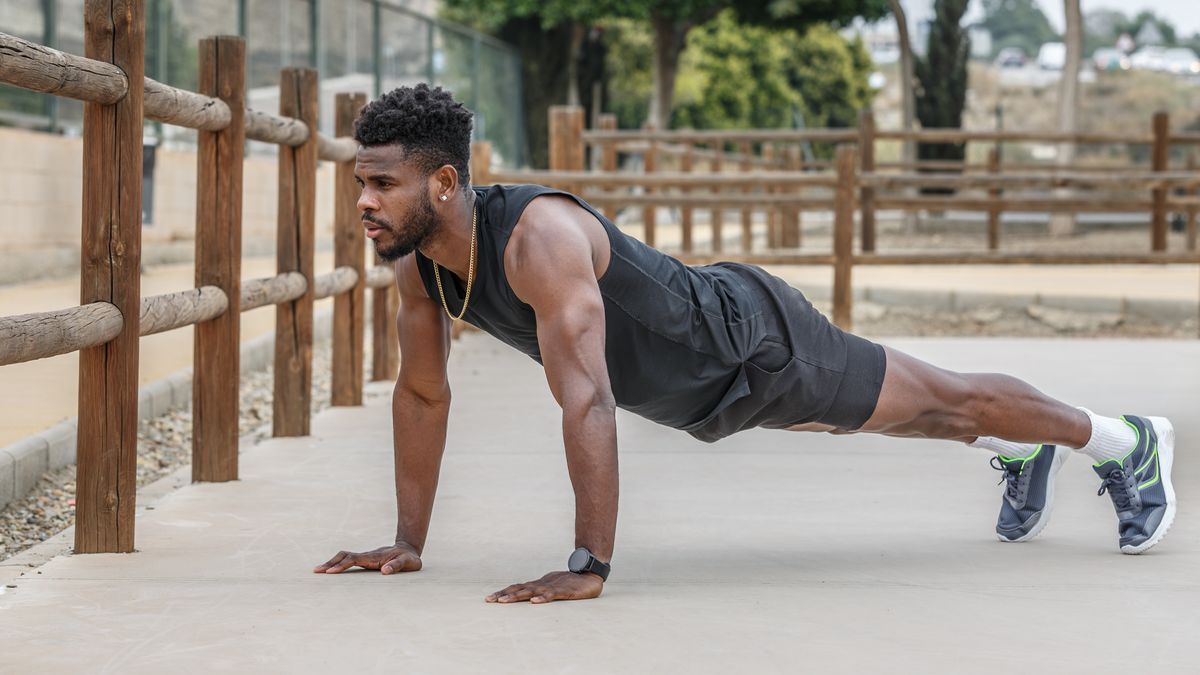 Man holding a plank position outside