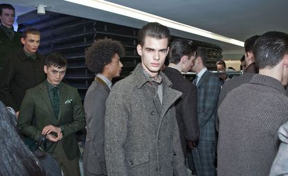 A Room full of male models with one posing directly at the camera