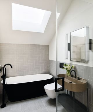 Awkward shaped bathroom with black bath tub