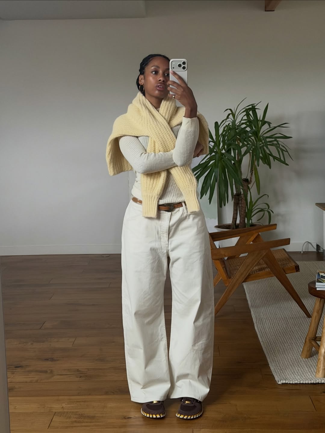 Claire in white denim outfit with yellow knit