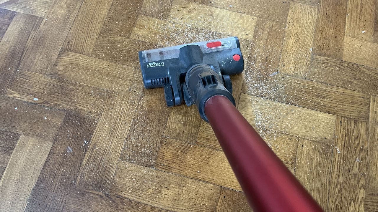 Henry Quick vacuuming sugar from hard floor
