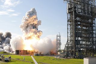 A Delta 2 Heavy rocket carrying NASA's twin Gravity Recovery and Interior Laboratory (GRAIL) mission lifts off from Space Launch Complex 17B on Cape Canaveral Air Force Station in Florida. At the right stands the pad's mobile service tower. The spacecraft