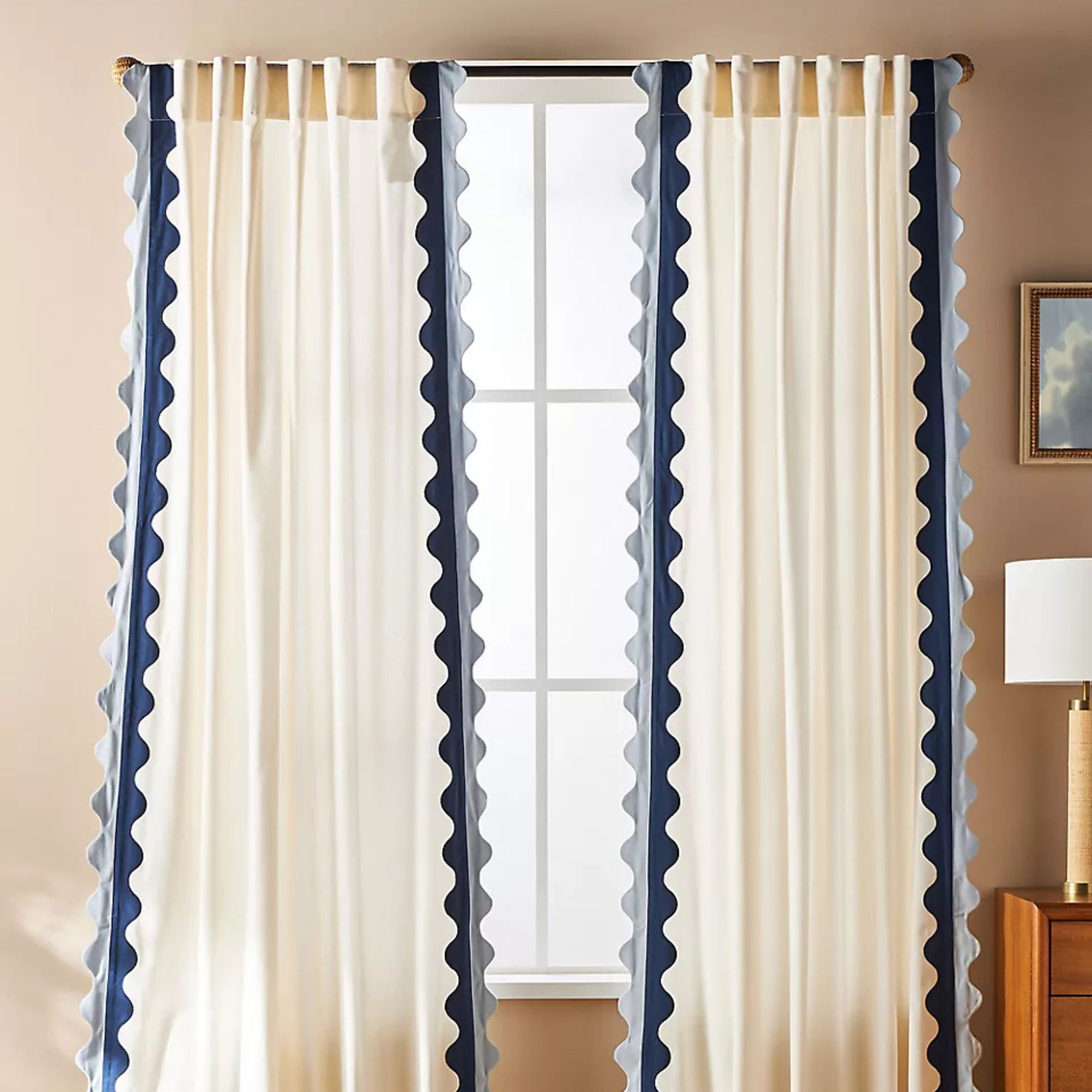Cream curtains with blue scalloped trim