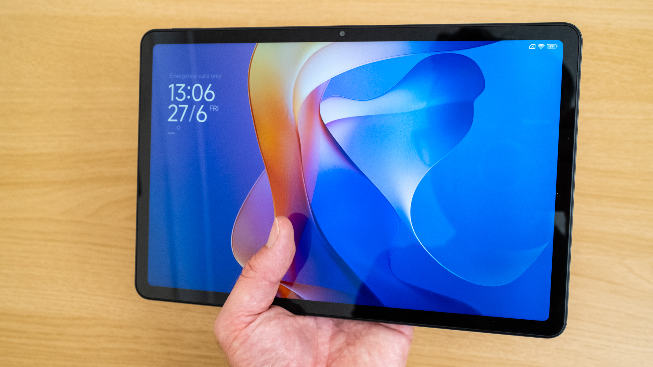 Xiaomi Redmi Pad 2 being held in a hand to show its size