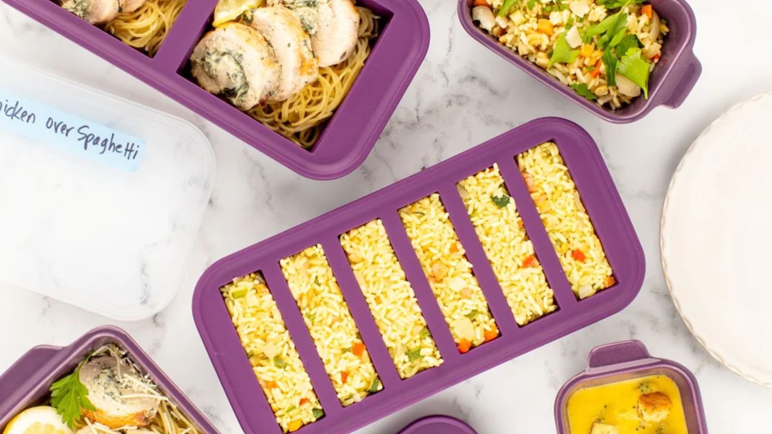A set of deep purple silicone food storage split into strips, filled with rice. 
