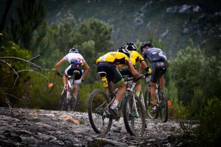 Kevin Evans and David George chase Christoph Sauser and Max Knox up a stony ascent.