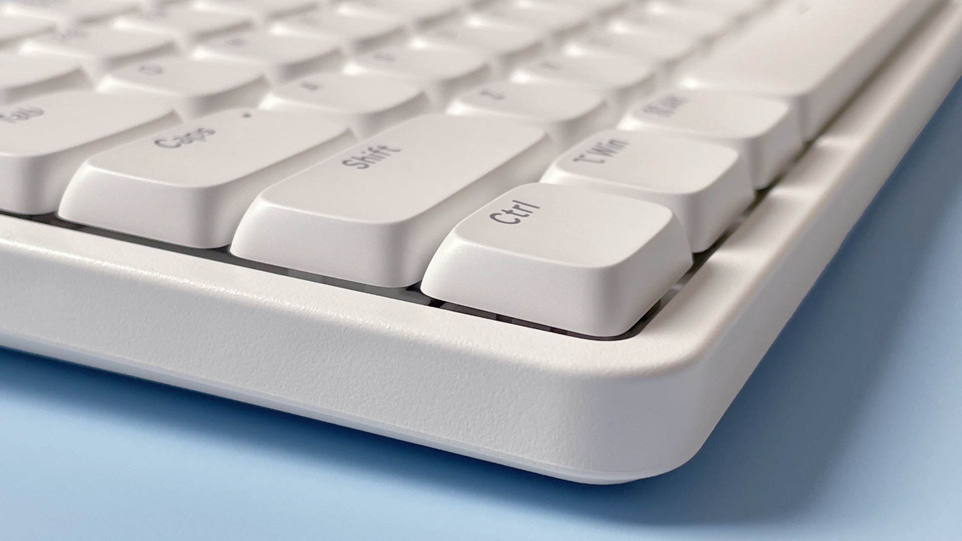 The Lofree Flow Lite mechanical keyboard against a blue background.