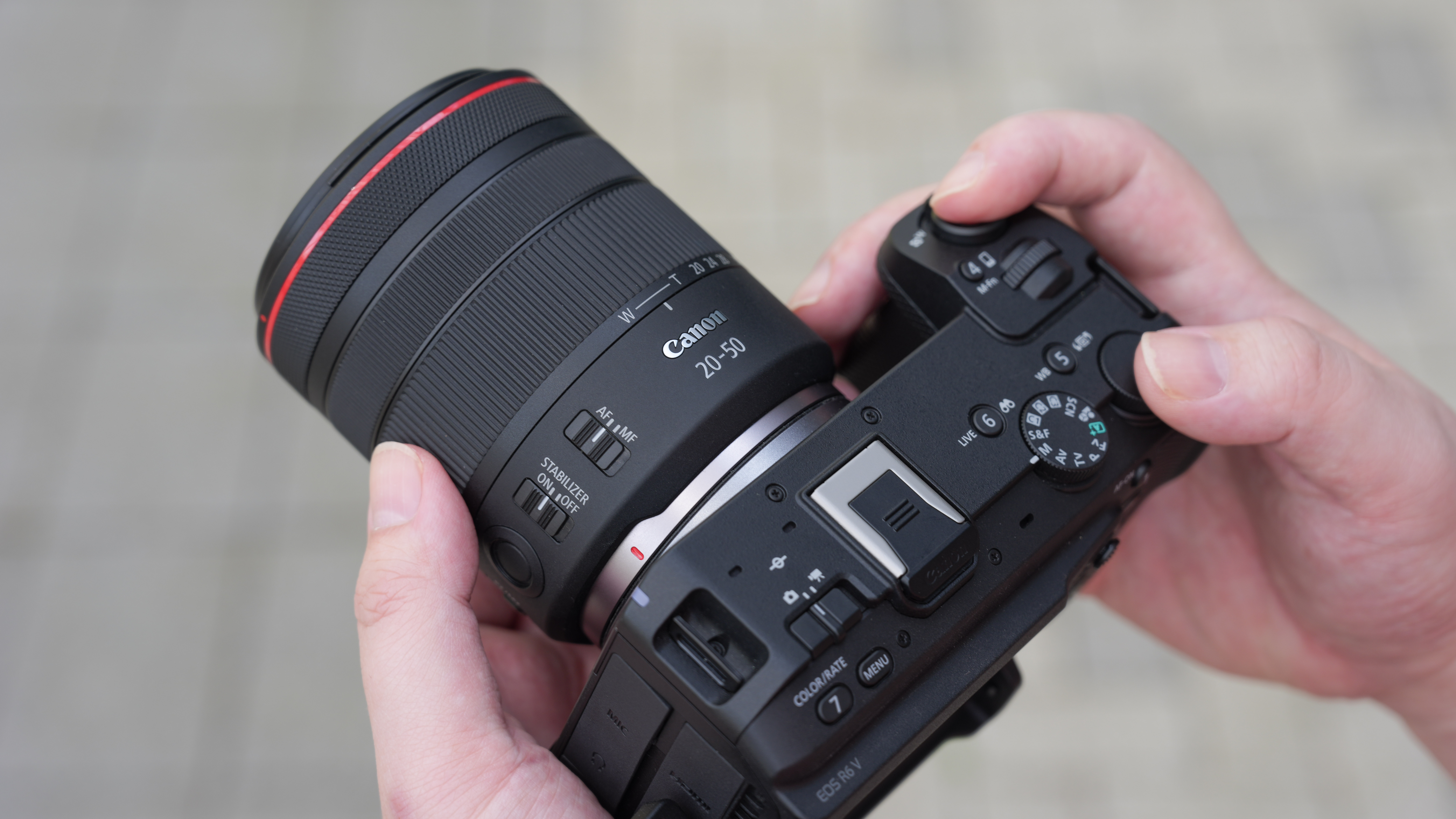 Canon EOS R6 V with the Canon RF 20-50mm f/4L IS USM PZ being held outdoors
