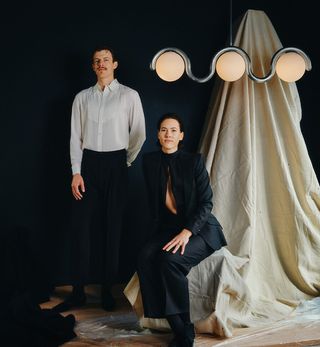 Astraeus Clarke, photographed by Heather Sten, in their soon-to-open showroom space in Manhattan, with their ‘Lenox 3 Globe’ lamp