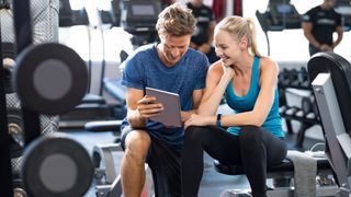 Woman with personal trainer in gym