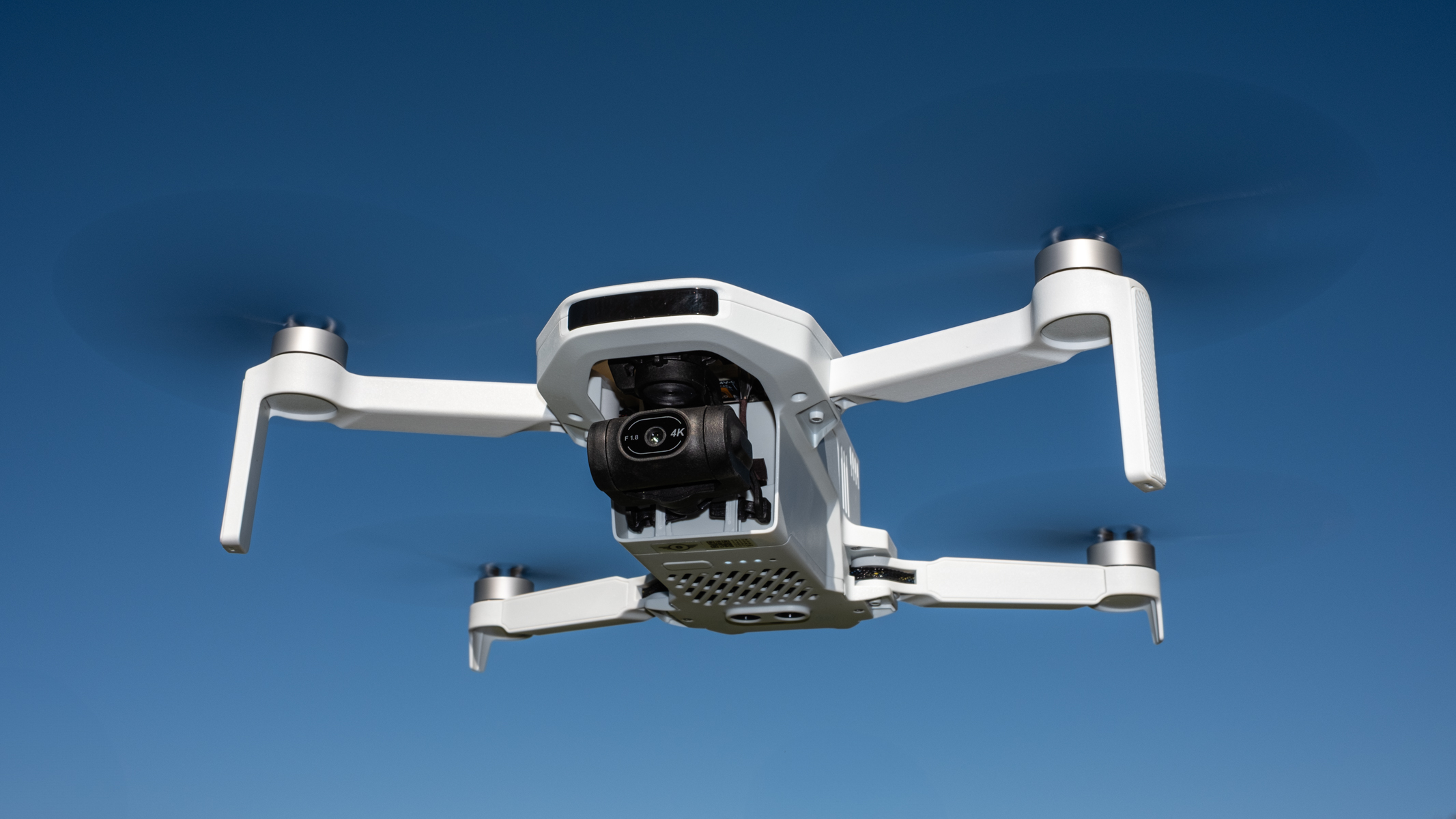 Potensic Atom 2 in flight against a blue sky