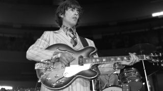 English Rock and Pop musician George Harrison (1943 - 2001), of the group the Beatles, plays guitar as he performs onstage at Olympia Stadium, Detroit, Michigan, August 13, 1966.