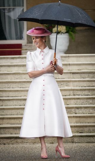 Zara Tindall in London wearing a white dress with pink buttons