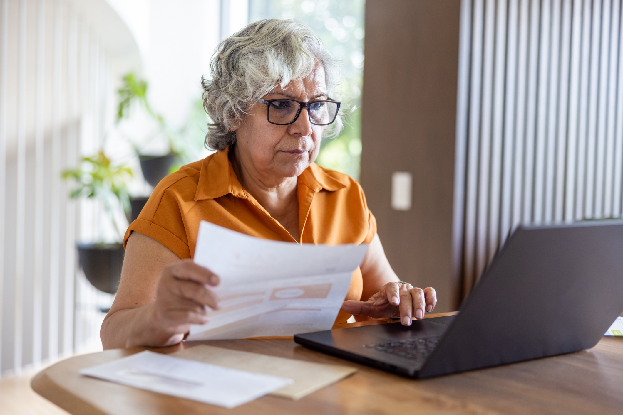 Pension saver reviewing her pension and ISA savings on a computer