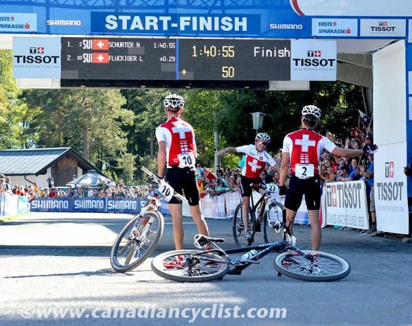The top three men - all Swiss - celebrate their finishes. Nino Schurter won ahead of Lukas and Mathias Flueckiger