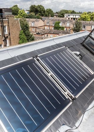 how to make an old home more energy efficient: solar panels on building roof