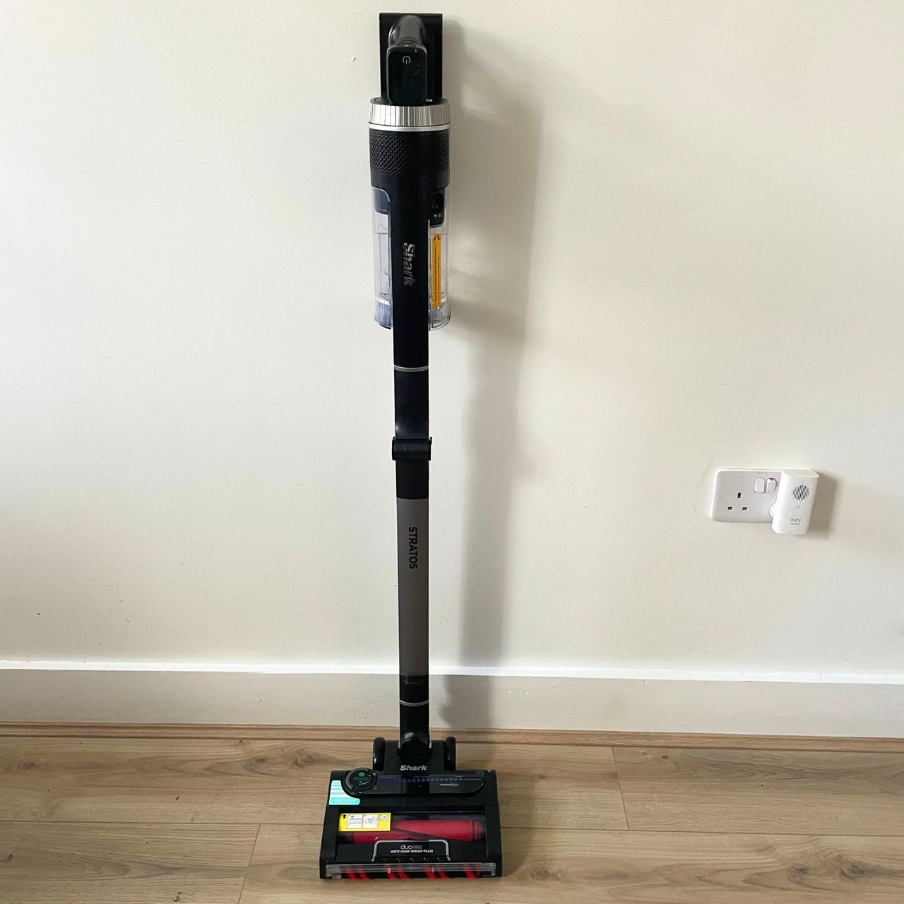 Shark Stratos Cordless Vacuum standing up against a white wall