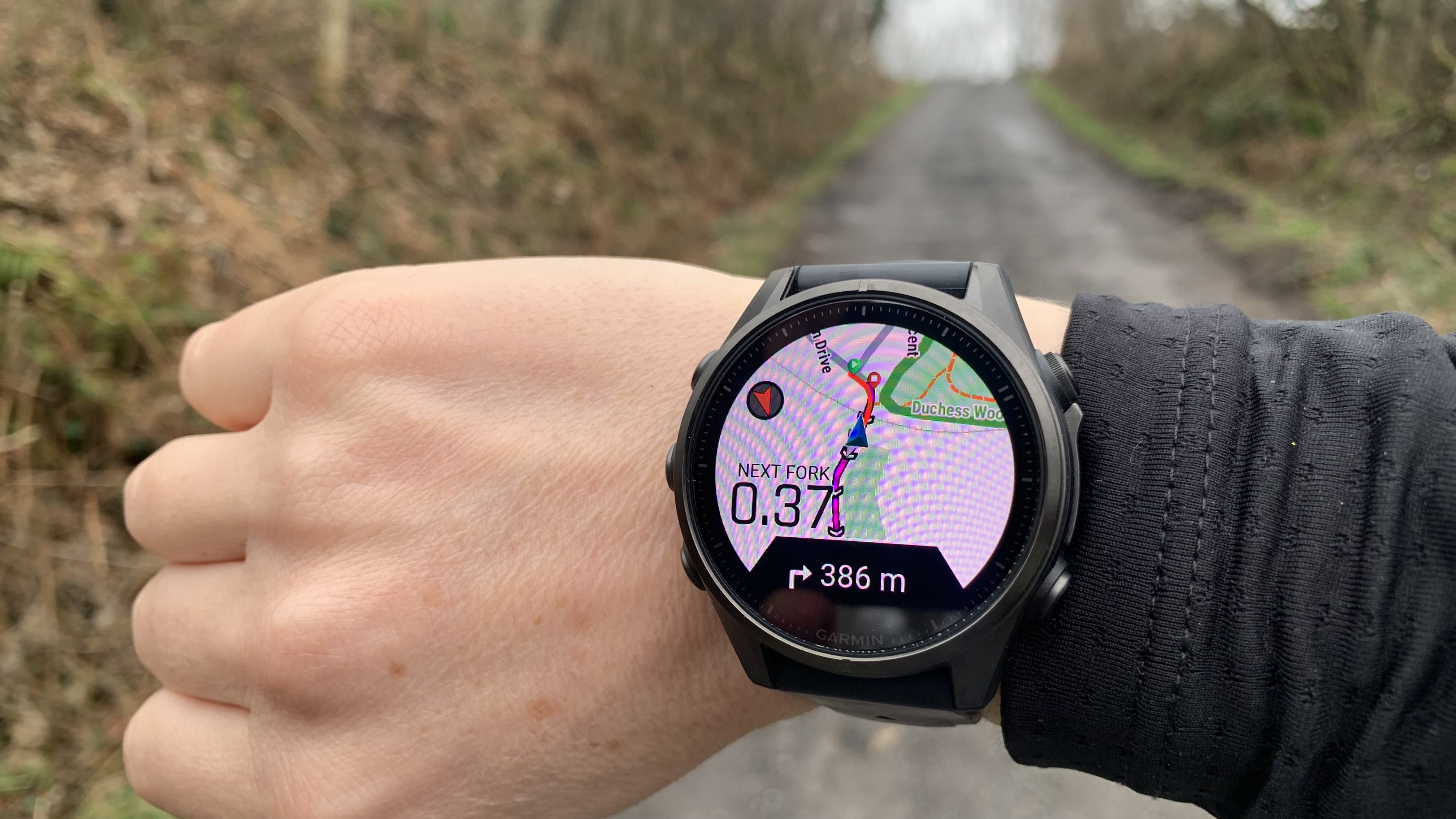 A hiker's wrist showing the map on the Garmin Fenix 8