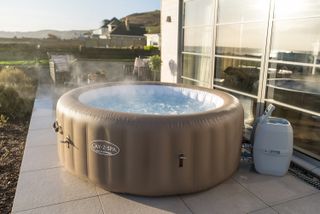 Lay-Z Spa palm springs inflatable hot tub on patio