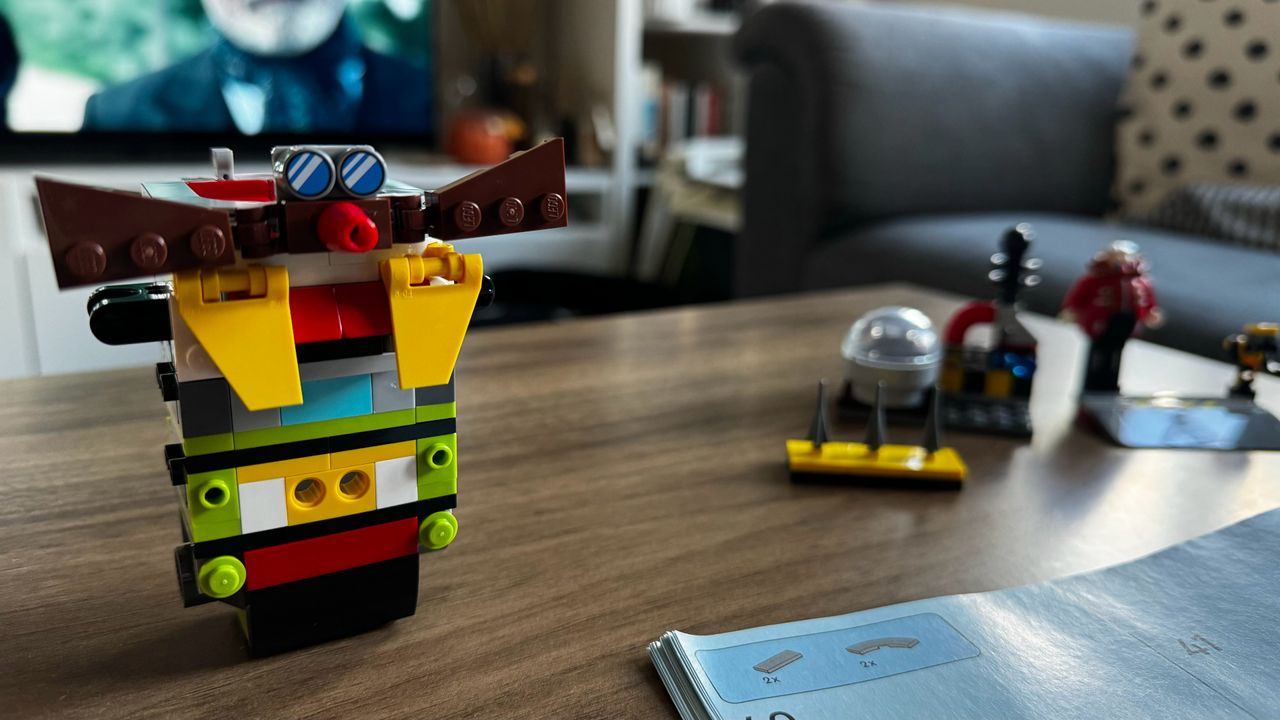 Lego Sonic vs. Dr. Eggman's Death Egg Robot set under construction on a wooden table