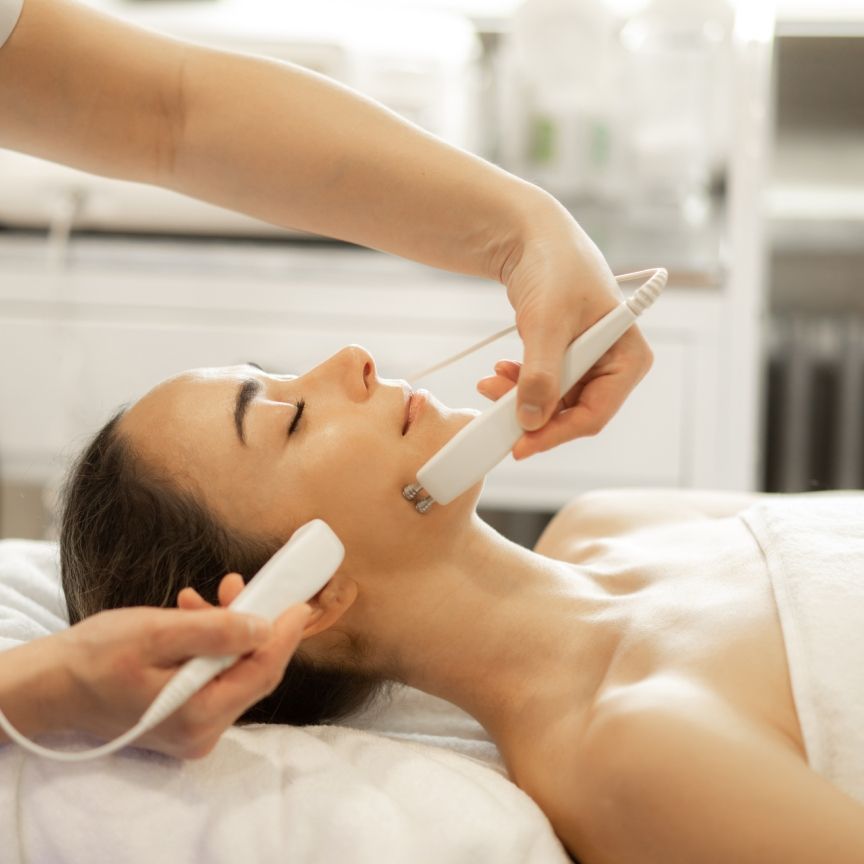  a woman lying down receiving a skincare treatment