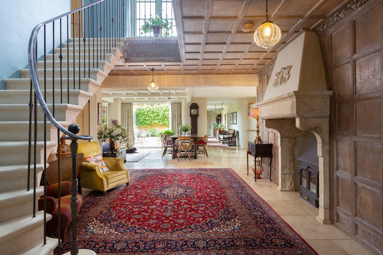 Details of the Lime House in Yorkshire. It is yellow, with a red tiled roof surrounded by green fields. Inside, wood panelled walls contrast with stone fittings and floors for a very farmhouse feel.