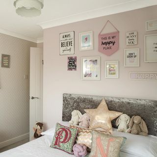 Pink bedroom with gallery wall and grey velvet headboard
