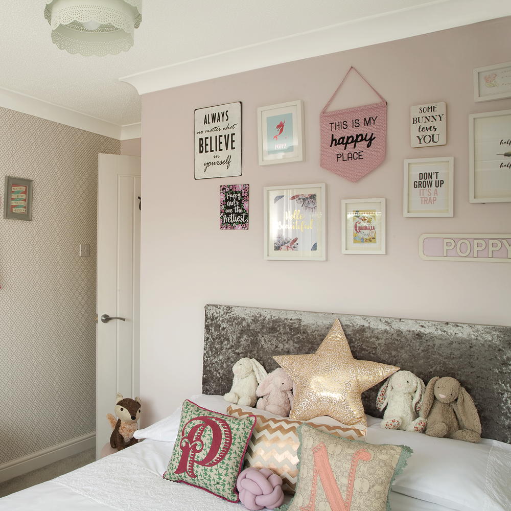 girls pink bedroom with bed and toys