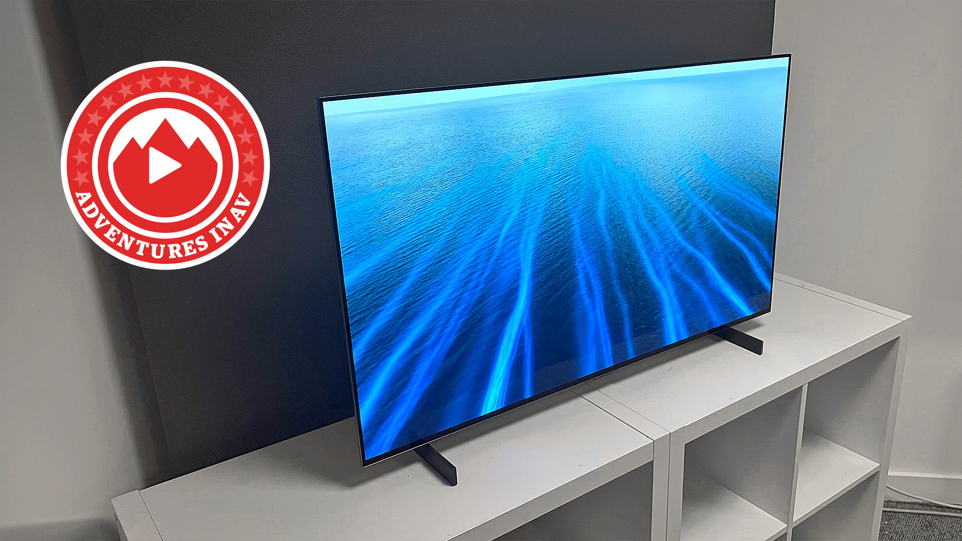 A 42-inch OLED TV with a blue neon pattern on screen