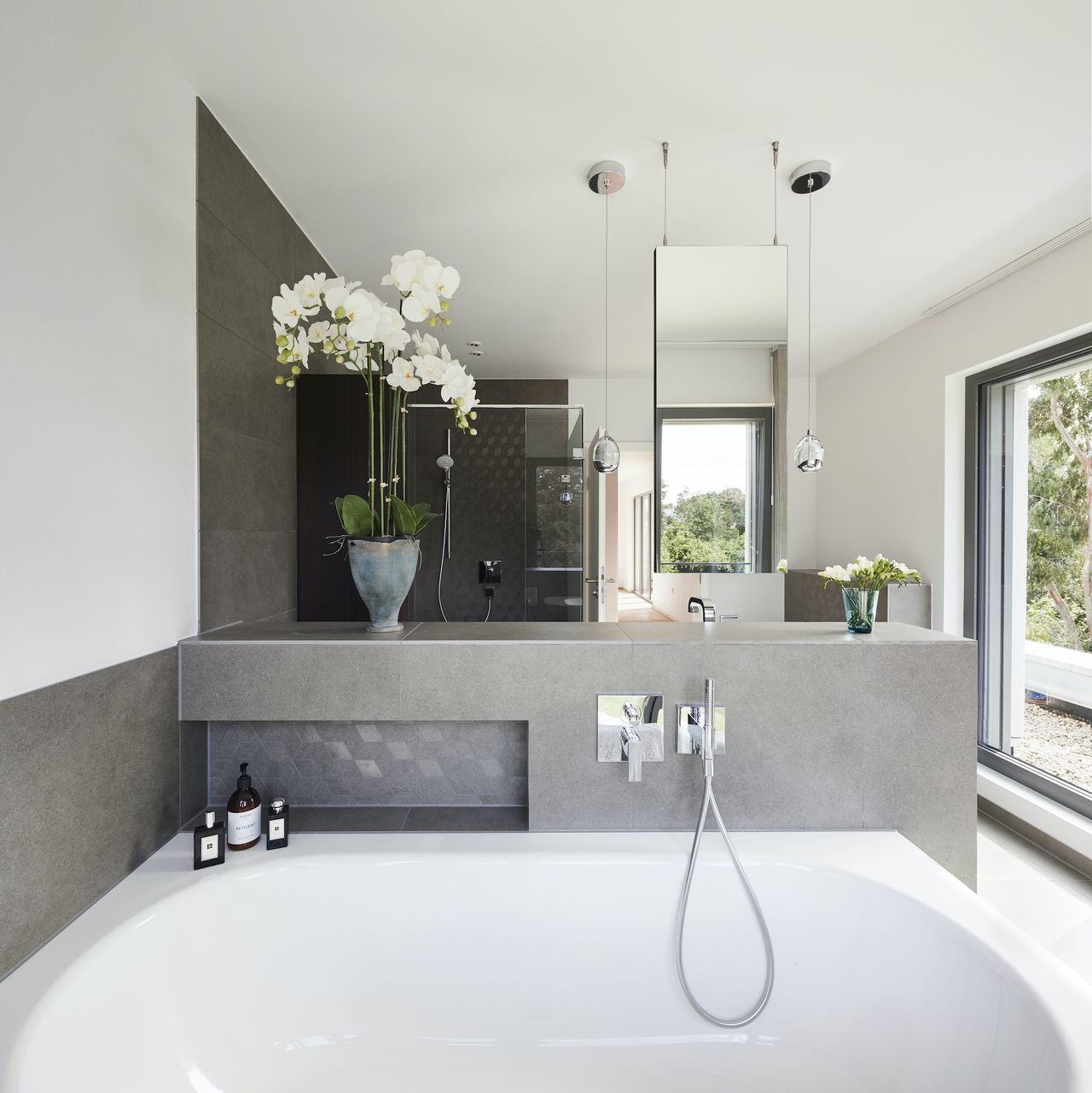 grey bathroom with bath in self build house