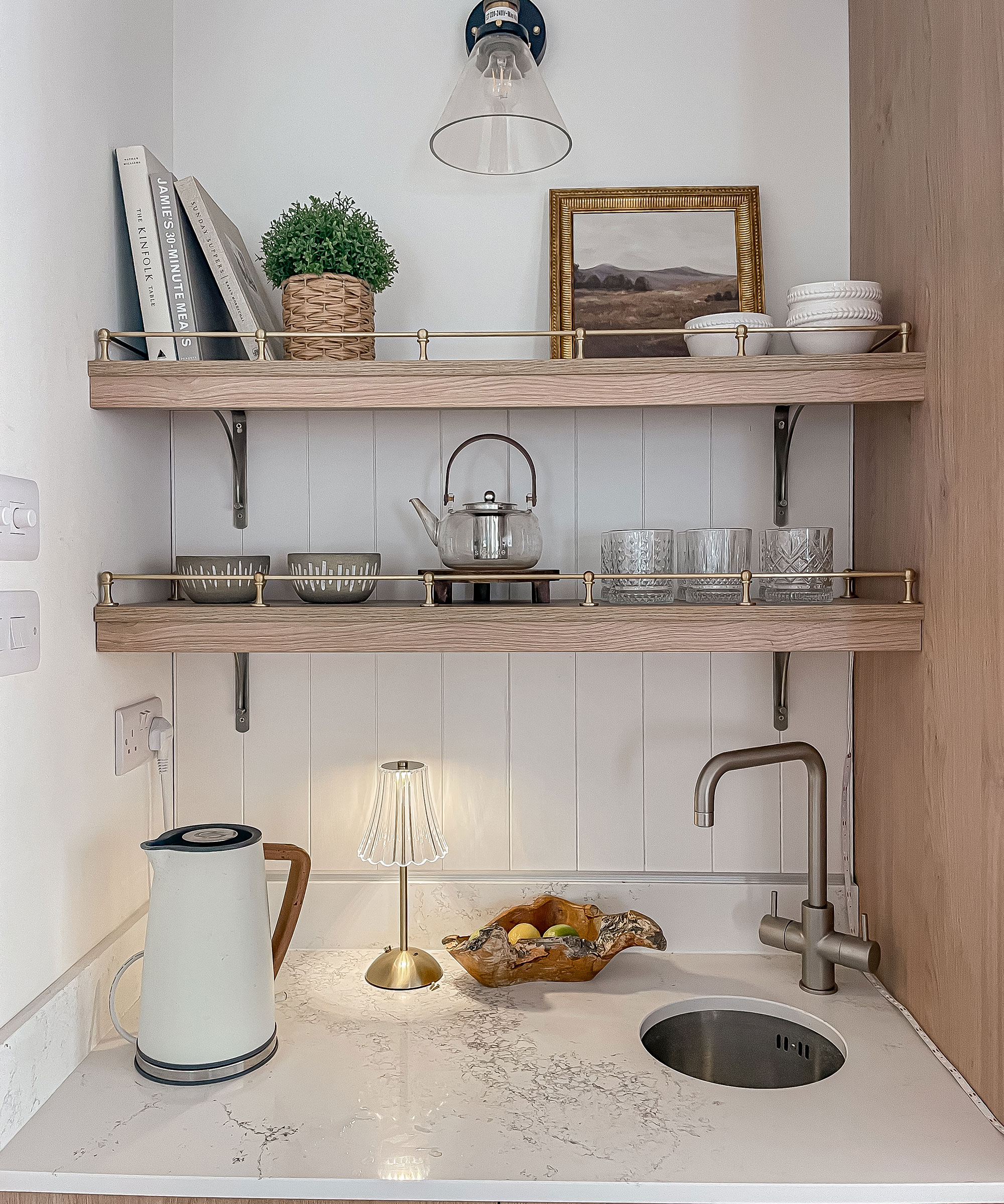 small kitchen with integrated round sink and open shelving