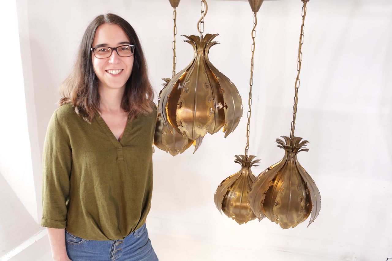 Lighting restorer Jolene Farmer with a restored Sven Sorensen Petal Light.